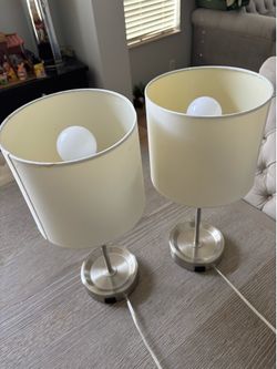 Lamp with a power outlet in the base