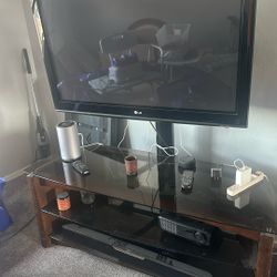 LG 40 inch smart TV with glass shelf entertainment center