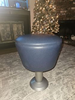 10 pieces
a modern stool with a blue faux leather seat on a metal base.