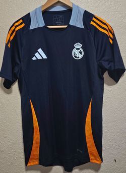 adidas Real Madrid 2024/25 training jersey navy base with distinct orange and light blue accents. PRE-LOVED 
Excellent condition 
Adult Size Small/med