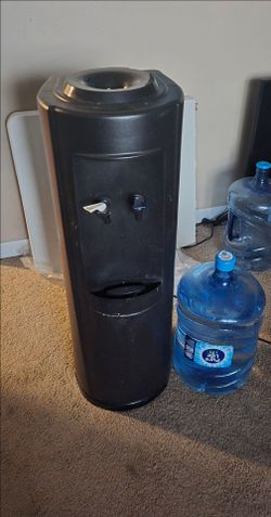 Water dispenser with new 5 gallon water jug and 1 empty one