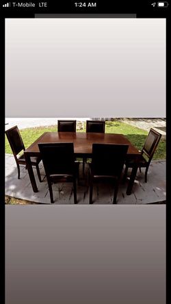 Beautiful wood dining table with 6 leather seat chairs in good condition.....will deliver