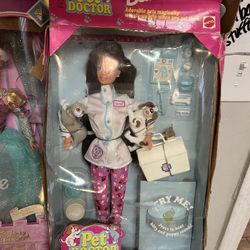 Pet Doctor Barbie doll from 1996. This specific version features a brunette doll in a vet outfit with animal patients that make sounds. Box damage $15