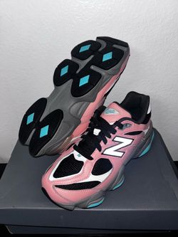 New Balance 9060 sneakers in a pink, black, and grey colorway