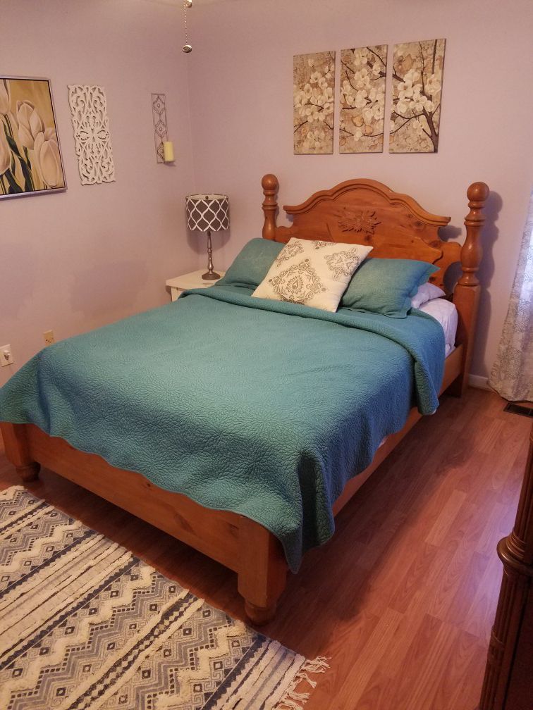 Queen sized bed frame with headboard and footboard.