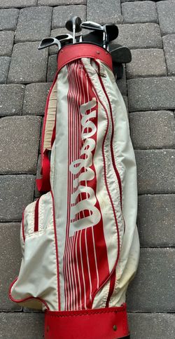 Wilson red and white gold bag with clubs set .