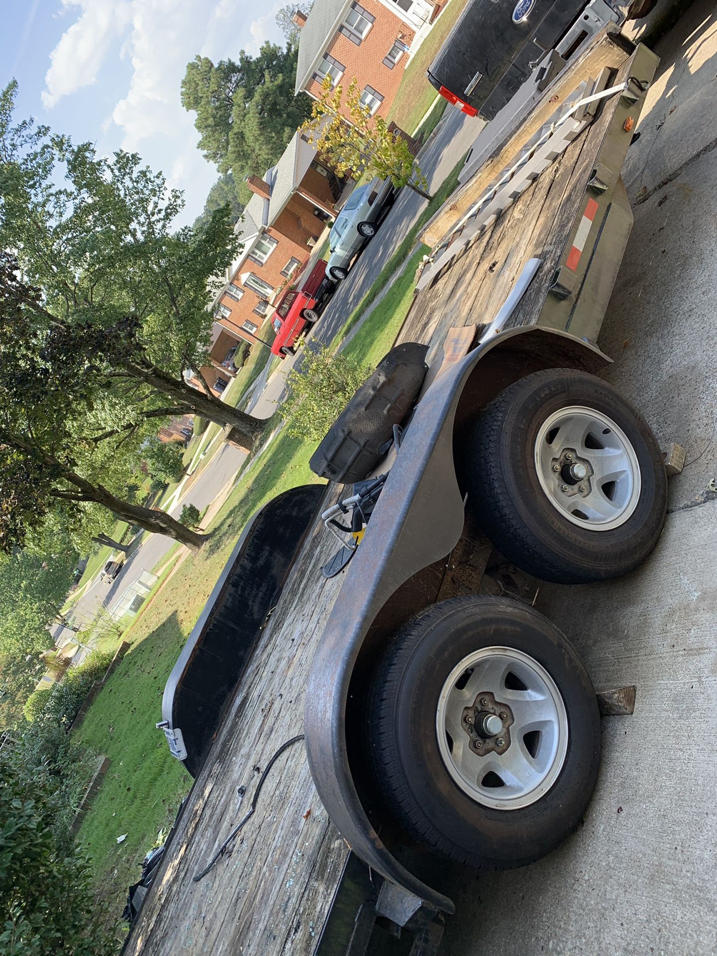 Car trailer with extra tire and straps