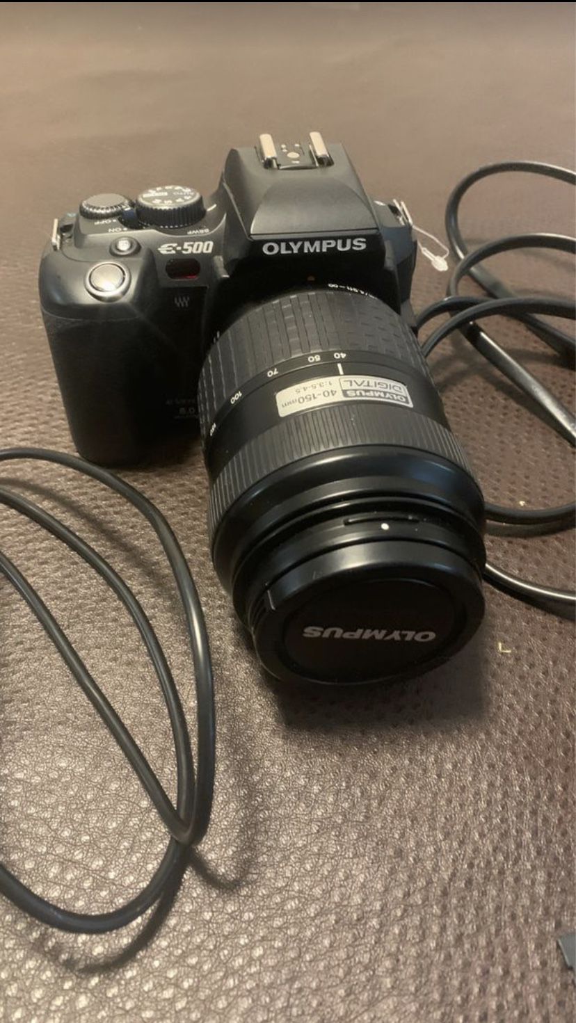 Olympus e 500 camera with battery charger, usb connector and a 1GB XD card