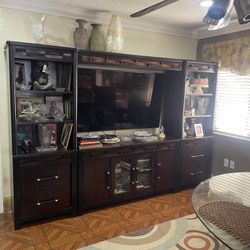 Entertainment center. Tv Console with surround glass dividers shelving, glass lower doors & lower drawers 