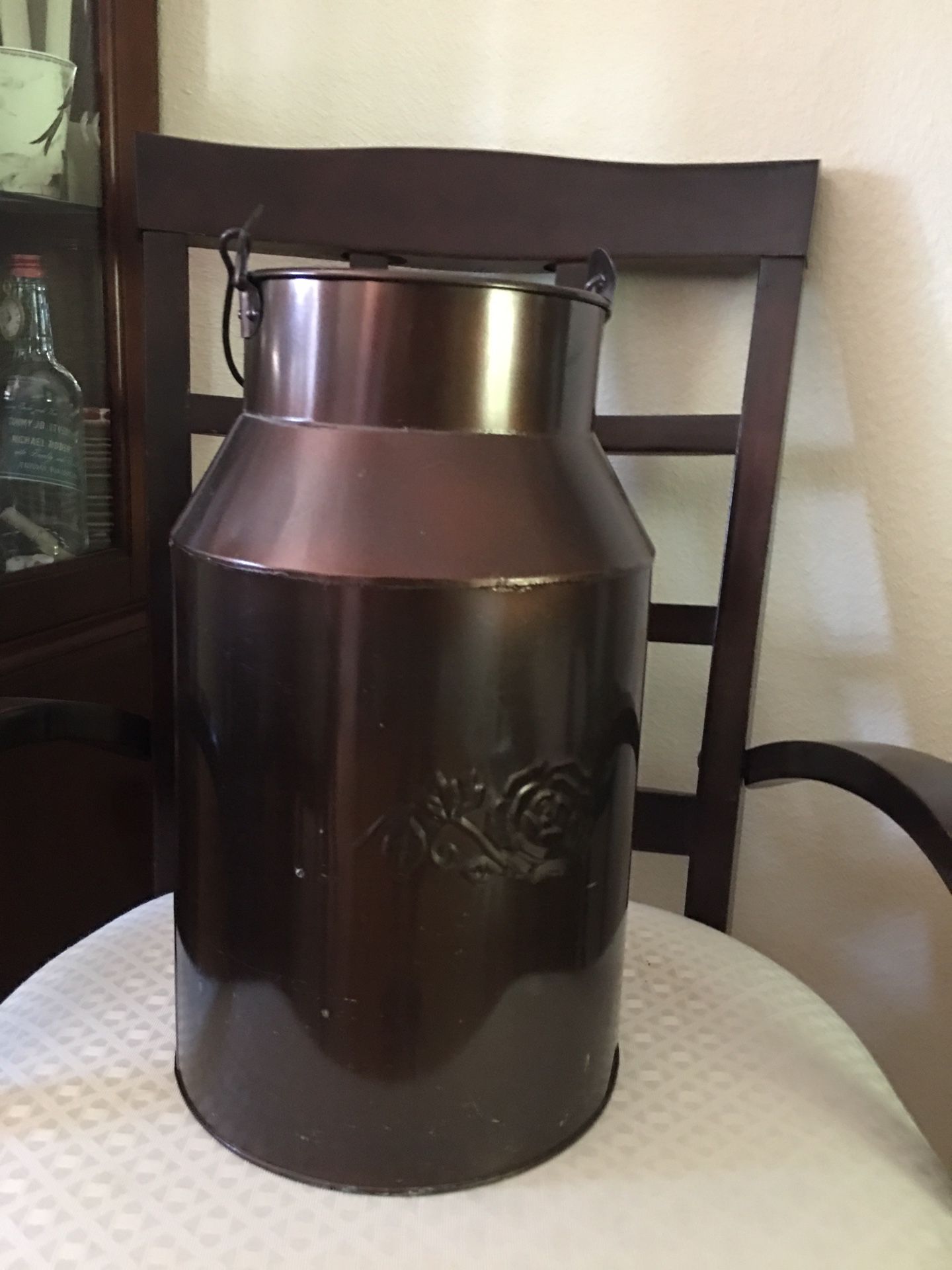 Milk can tin about 16” talk. Nice rose on each side. Decorative and used to hold scented pine cones in our home.