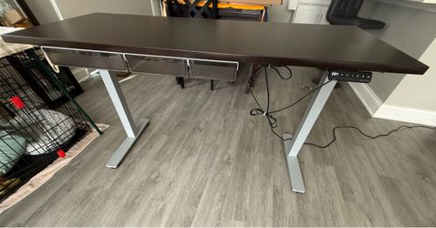 Standing desk surface top is 23.5 in deep and 59 in long