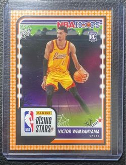 2023-24 NBA Hoops Victor Wembanyama Haunted Hoops Orange Parallel “Rising Stars” Rookie Card Spurs #282