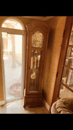 The Tempus Fugit Grandfather Clock is an antique longcase clock made of wood
