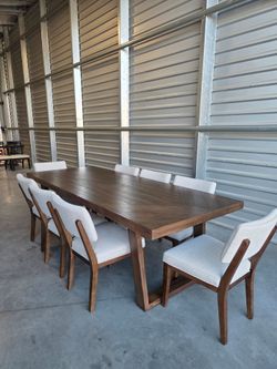 Galena 9-piece Dining Table Set
Brown Finish
Mahogany Solids and Mindy Veneers
Seats Upholstered in Gray Performance Fabric
Decorative Plank Top