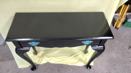 Sharp design!!! Refurbished wooden black table with pull out drawer.  31 by 12 by 29