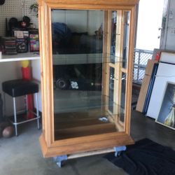 Oak Cabinet With Two Glass Shelves With beveled front piece of glass 1 inch bevel