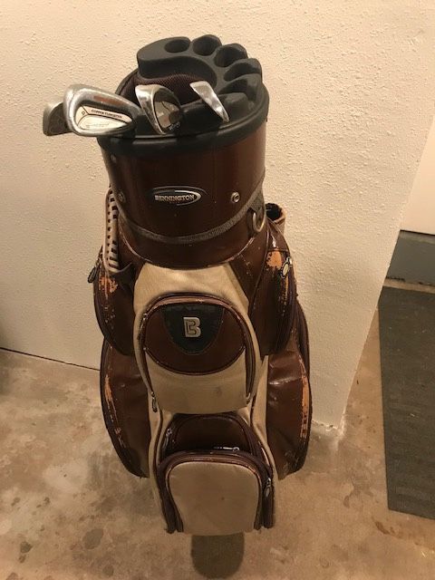 Old School Golf bag with a few misc clubs.