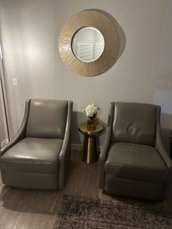 2 gray leather swivel chairs
