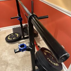 7ft Barbell, Rack, And 210lbs Of Bumper Plates 