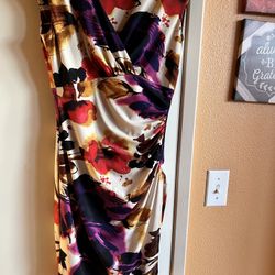 Ralph Lauren Chic asymmetrical dress with bold floral patterns. Features vibrant red and purple hues. Ideal for stylish outings.  New no tags. Size 2.