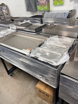 Stainless griddle with warmers with hose.