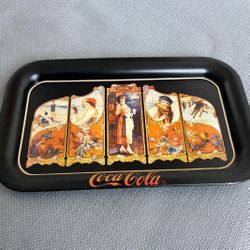 The item is a vintage Coca-Cola serving tray, a reproduction of a 1923 design …copyrighted  in 1990… 14 “ x 9”. $20