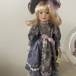 Porcelain doll Collector’s Choice, in a Beautiful and elegant purple dress