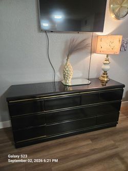 Black Dresser with Gold Trim Accents