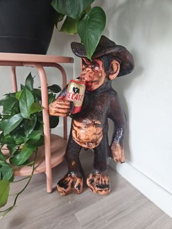 Ceramic monkey drinking beer