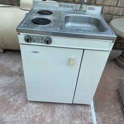 Denby (Danby) compact kitchen unit, which is an all-in-one appliance designed for small spaces like dorm rooms, offices, or cottages. 