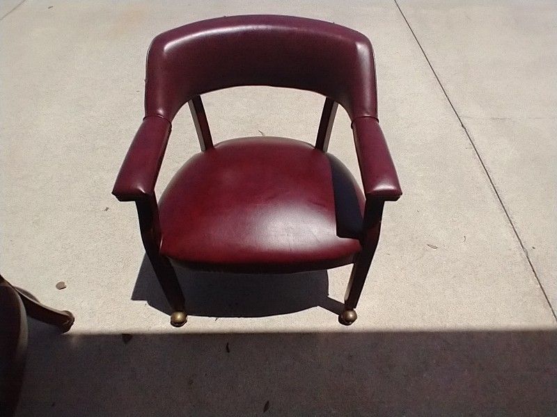 2 Burgundy Leather Captains Chairs 
On Rolling Casters