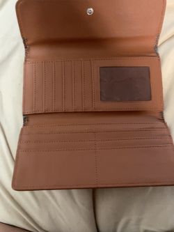 Good condition. Genuine leather. Multiple card slots and zip pocket.