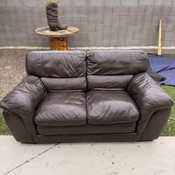 Brown leather loveseat