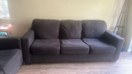 Dark grey couches with dark blue covers