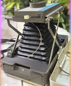 Vintage Polaroid folding bellows instant camera in gray with metal support arms and accordion-style bellows TESTED WORKS
