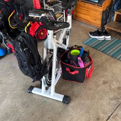 Spinning Bike. With Backpack And Physical Therapy Accessories 