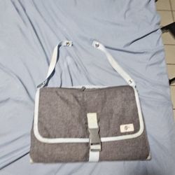Munchkin Portable Diaper Changing Kit in gray with white trim. 