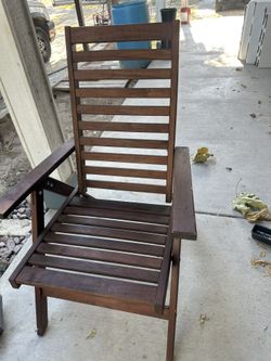 dark brown stain and a slatted hardwood design. It is highly functional, offering 5 adjustable reclining positions and a foldable mechanism that allow