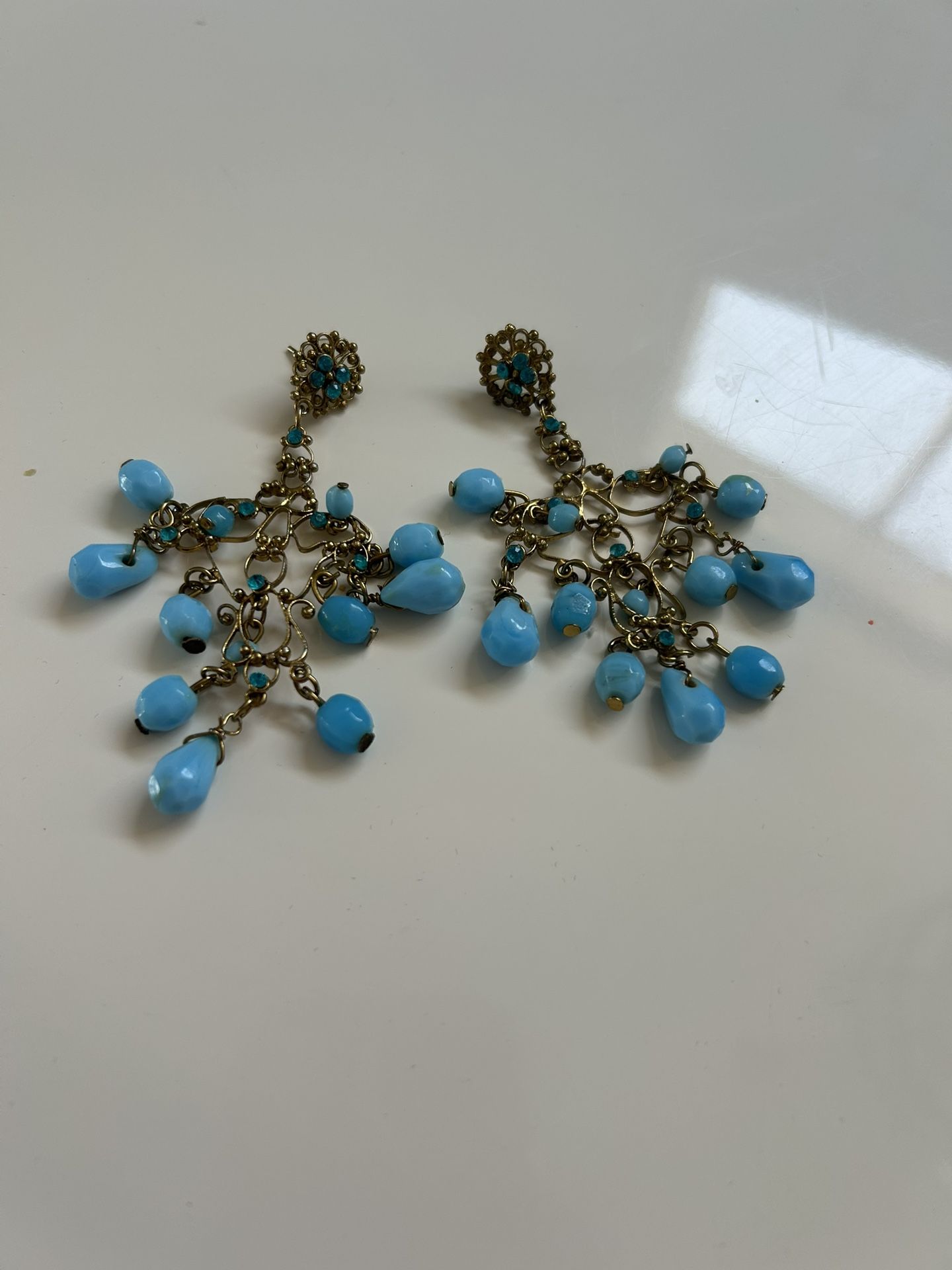 A statement earring. Turquoise glass beads and gold chandelier costume jewelry earrings