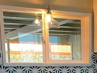 Brushed nickel and glass pendant light.