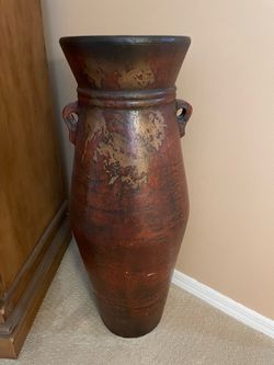 Tall, decorative clay pot