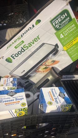 Vacuum sealer with sealing bags and food cooker
