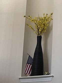 big black vase with decor flowers