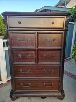 Tall Dark Wood Dresser with Carved Details