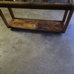 A Wooden Console Table With Glass Inserts