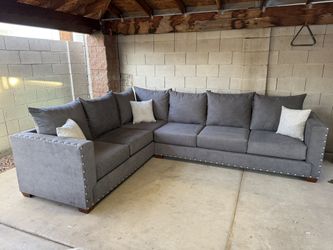 8x10 “L” sectional gray fabric with silver nail heads