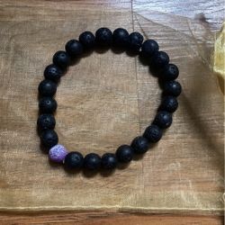 Black Lava Stone With Purple Crackle Stone In It 
