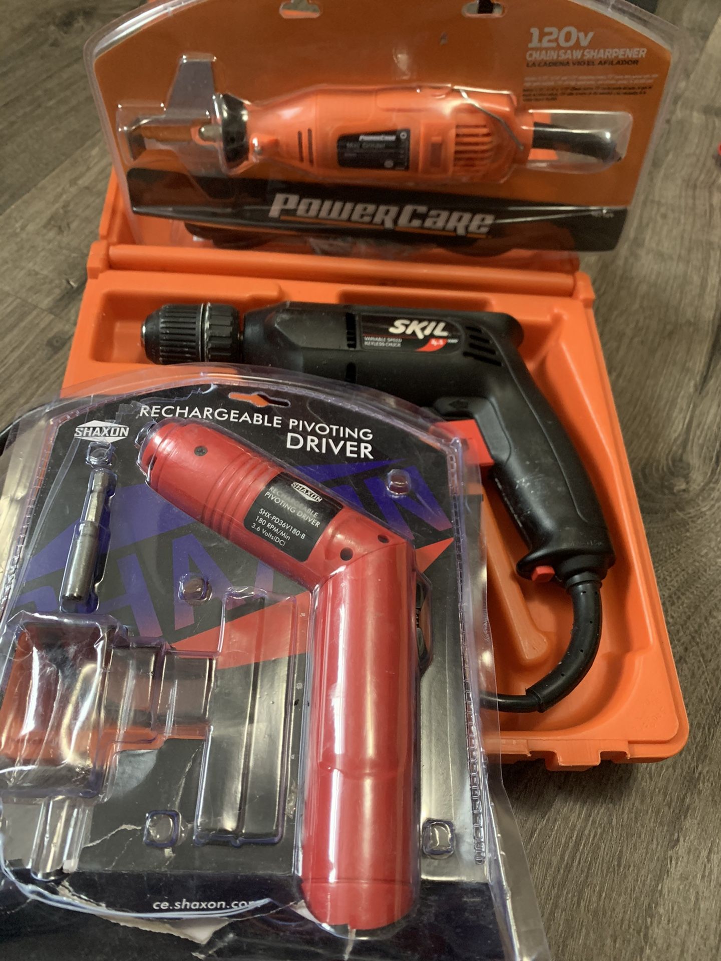 Set of corded drill, chain sharpener, and rechargeable driver.