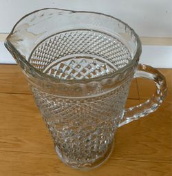 Fancy glass pitcher, ornate, 9 1/2” tallX5” diameter.