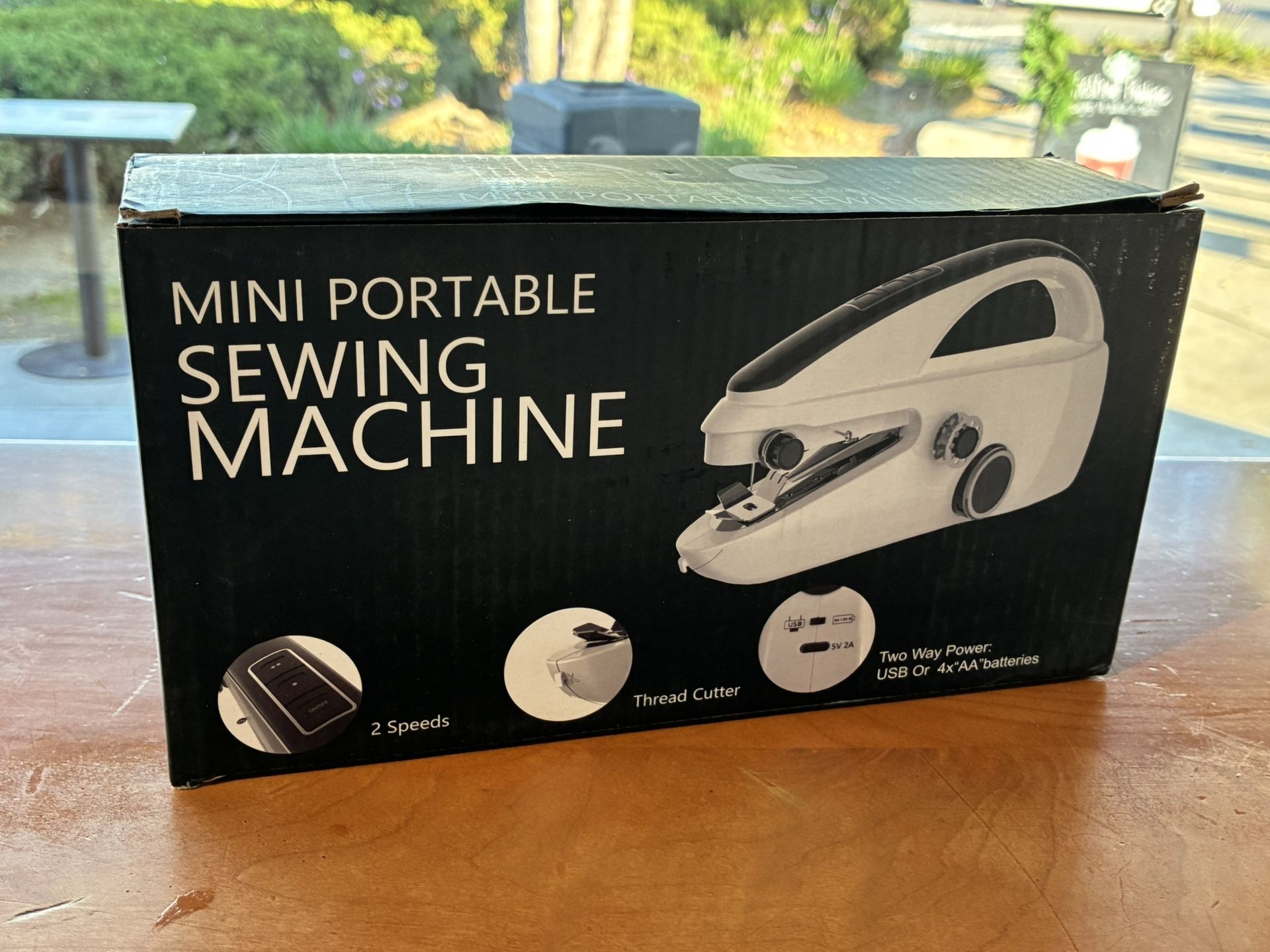 Mini sewing machine works with batteries or power cord